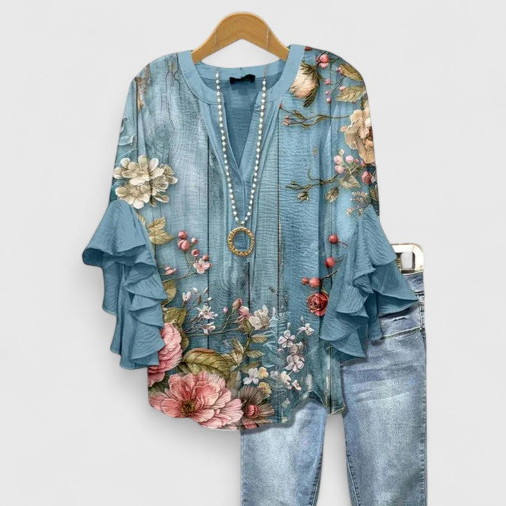 Blus dam med blommigt tryck och volangärmar i stor storlek